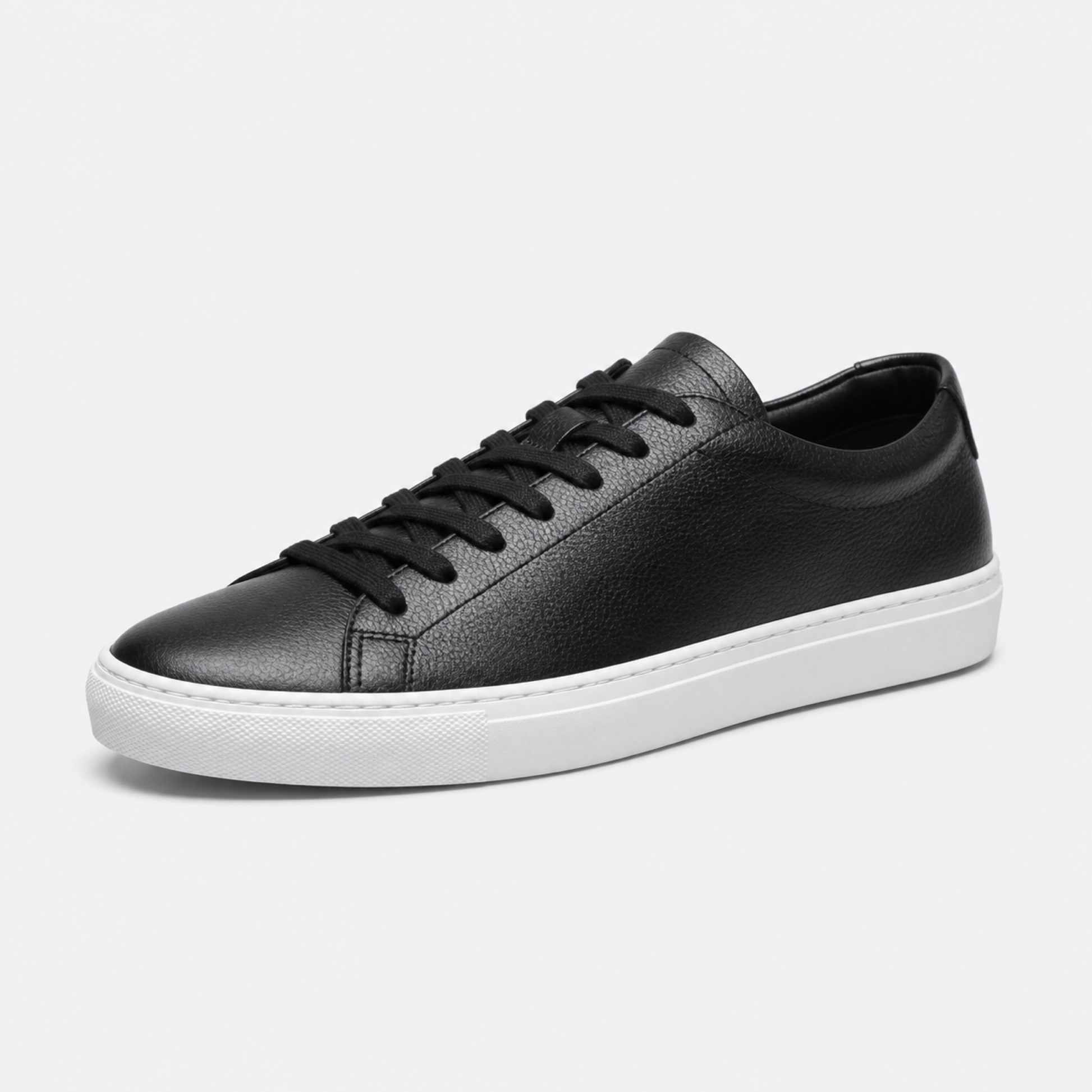 Black / White Sole classic leather low-top sneaker three-quarter view
